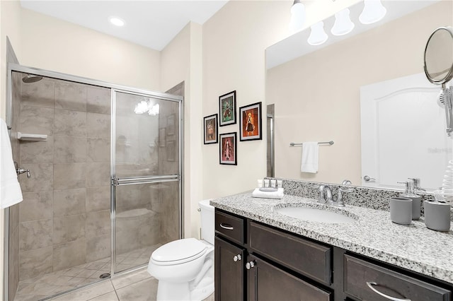 bathroom with walk in shower, tile patterned flooring, vanity, and toilet