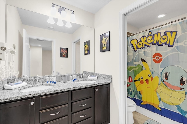 bathroom featuring a shower with curtain, vanity, and toilet