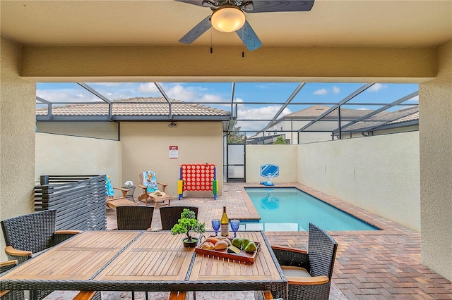 view of pool featuring a lanai, outdoor lounge area, a patio area, and ceiling fan