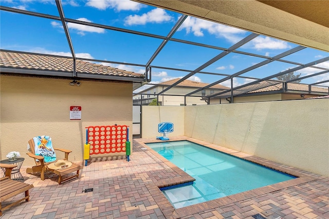 view of swimming pool with a lanai and a patio area