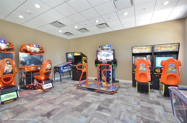 recreation room featuring carpet flooring and a paneled ceiling