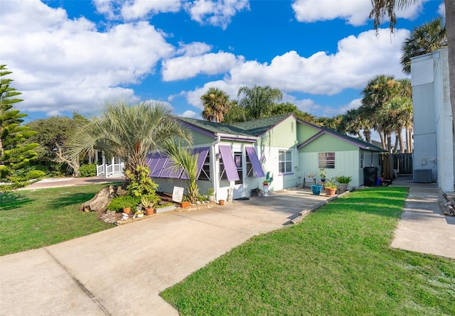 view of front of home with a front lawn and central AC unit