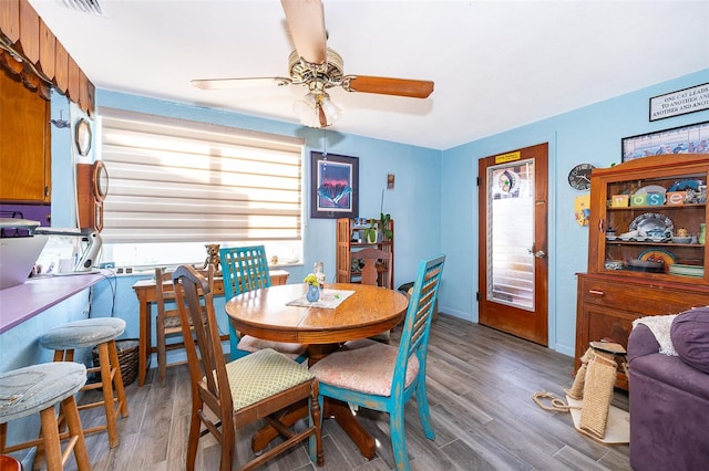 dining space featuring ceiling fan and hardwood / wood-style floors