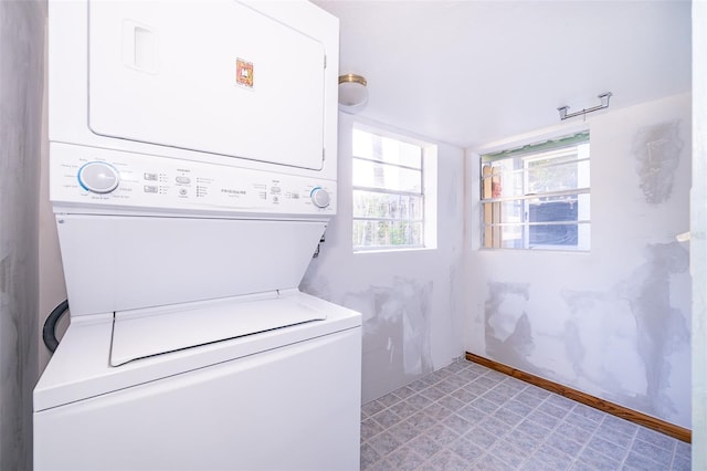 laundry area with stacked washer and clothes dryer