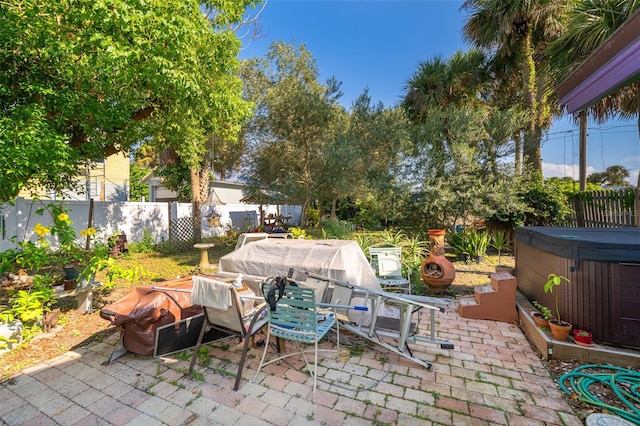 view of patio / terrace with a hot tub