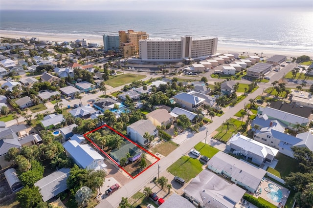 birds eye view of property featuring a view of the beach and a water view