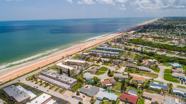 drone / aerial view featuring a water view and a beach view