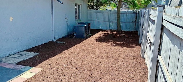 view of yard featuring central air condition unit