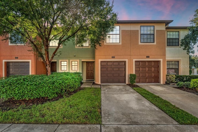 townhome / multi-family property featuring a garage