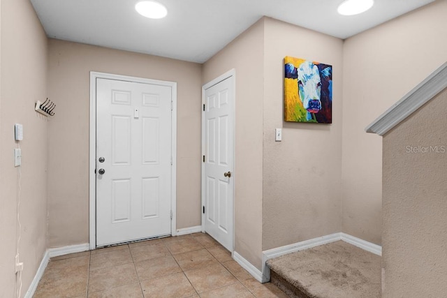 foyer entrance with light tile patterned floors