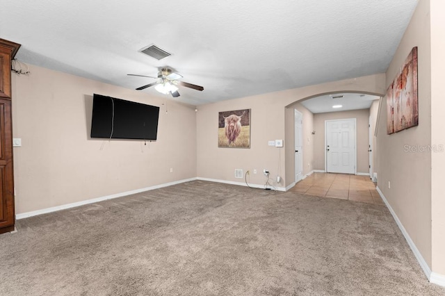 spare room featuring ceiling fan and light colored carpet