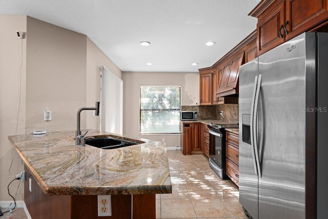 kitchen featuring sink, light tile patterned floors, backsplash, stainless steel appliances, and dark stone counters