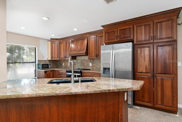 kitchen with sink, custom exhaust hood, stainless steel appliances, and light stone counters