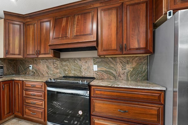 kitchen with black electric range oven, backsplash, and light stone counters