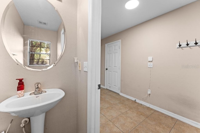 bathroom with tile patterned floors