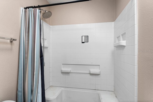 bathroom featuring shower with separate bathtub