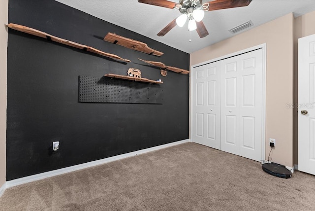 unfurnished bedroom with a closet, ceiling fan, and light colored carpet