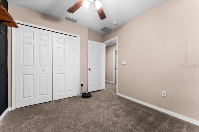 unfurnished bedroom featuring a closet, ceiling fan, and carpet floors