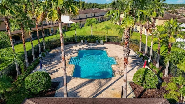 view of pool featuring a lawn and a patio area