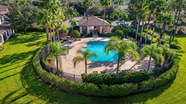 view of swimming pool featuring a lawn and a patio