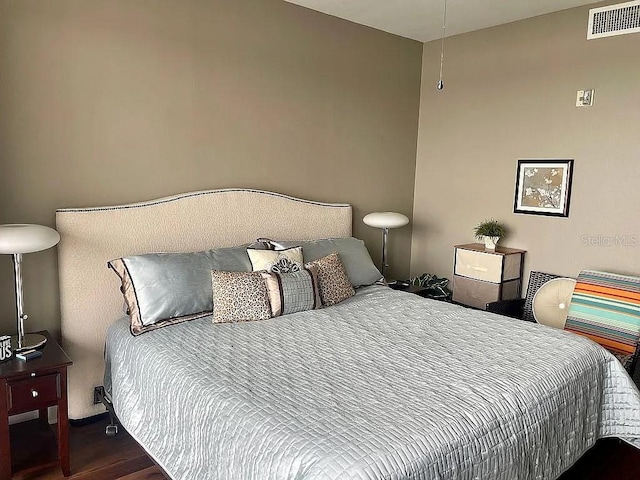 bedroom with dark wood-type flooring