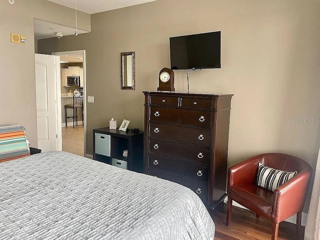 bedroom with hardwood / wood-style flooring