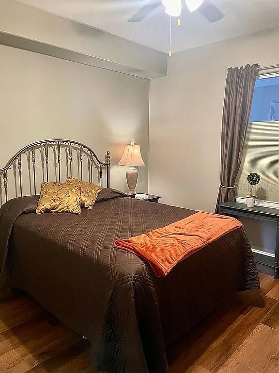 bedroom with ceiling fan and dark hardwood / wood-style floors