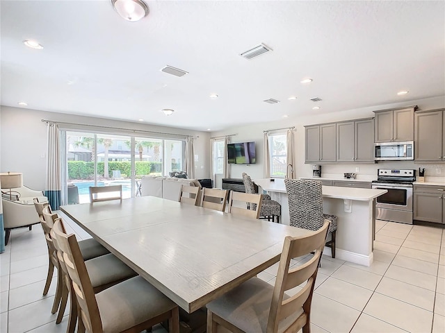 dining area with light tile patterned floors and sink