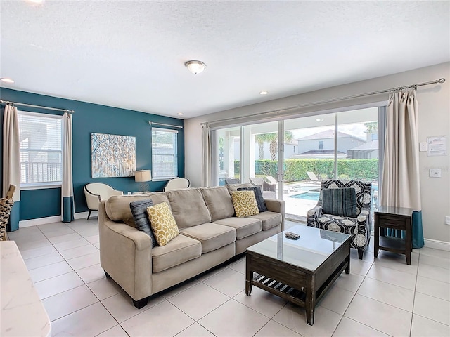 tiled living room featuring a textured ceiling