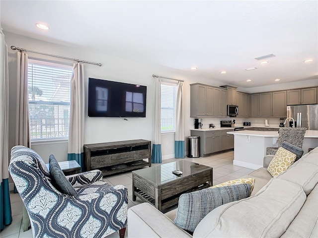 living room with a wealth of natural light and light tile patterned floors