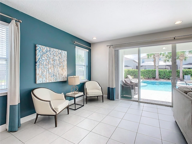 living area featuring light tile patterned floors and plenty of natural light