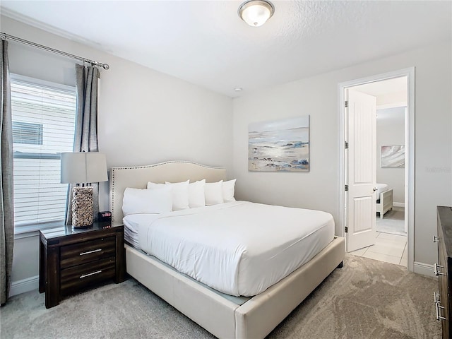 bedroom featuring light carpet