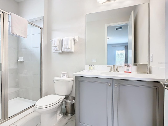 bathroom featuring vanity, toilet, tile patterned floors, and a shower with door