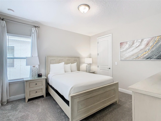 bedroom featuring dark colored carpet