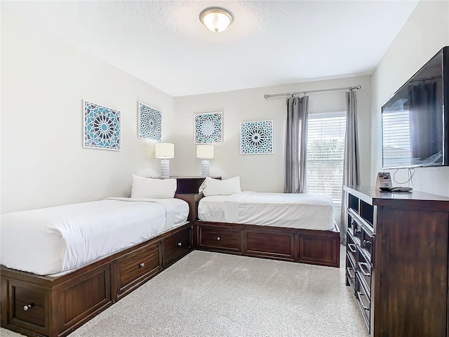 bedroom featuring light carpet