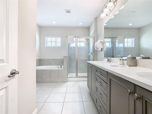 bathroom with tile patterned flooring, vanity, and separate shower and tub