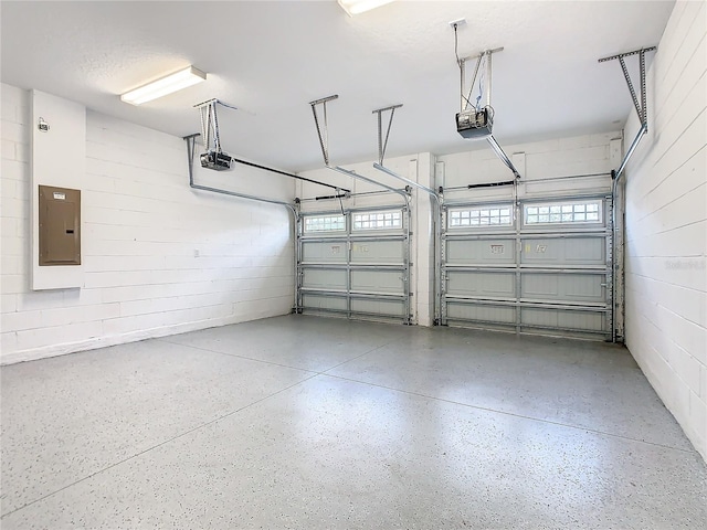 garage with electric panel and a garage door opener