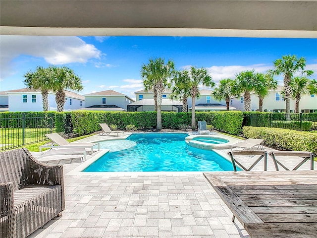 view of pool with a patio and an in ground hot tub