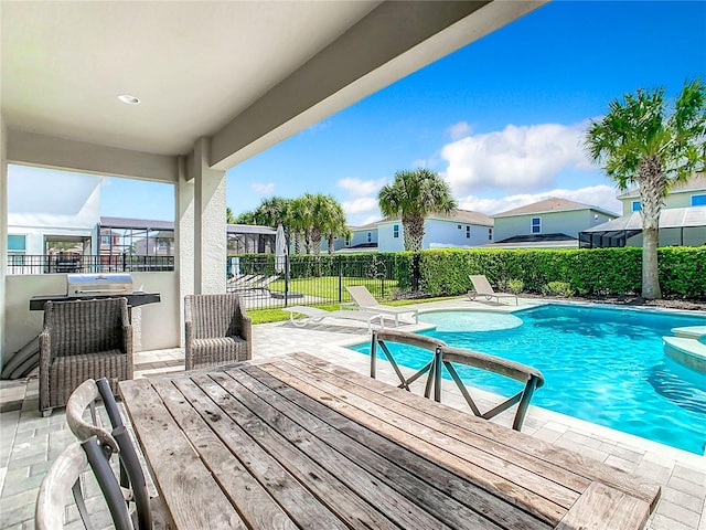 view of swimming pool featuring a hot tub and a patio