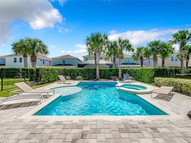 view of swimming pool with an in ground hot tub and a patio area