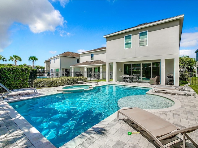 view of pool featuring an in ground hot tub and a patio area