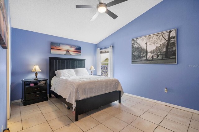 tiled bedroom featuring ceiling fan and vaulted ceiling