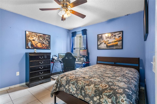 tiled bedroom with ceiling fan and a textured ceiling