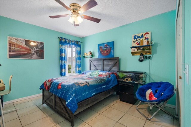 tiled bedroom with ceiling fan and a textured ceiling