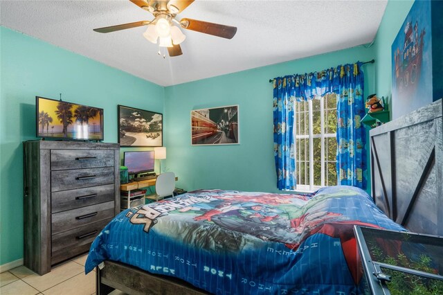 tiled bedroom featuring ceiling fan and a textured ceiling