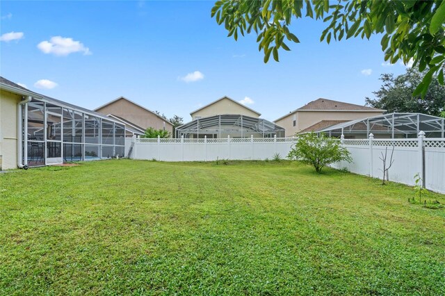 view of yard featuring glass enclosure