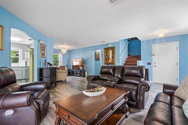 living room featuring hardwood / wood-style flooring and a textured ceiling