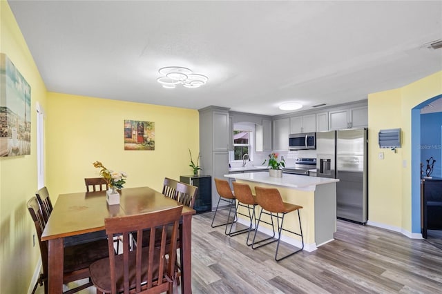 dining space featuring sink and light hardwood / wood-style flooring