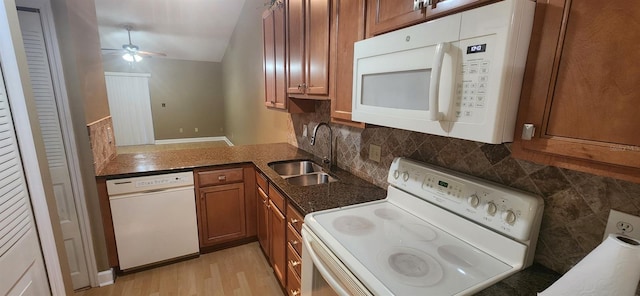 kitchen featuring tasteful backsplash, ceiling fan, light hardwood / wood-style flooring, sink, and white appliances