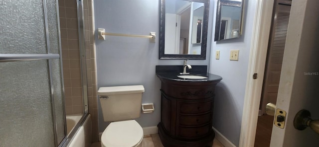 full bathroom with vanity, toilet, and shower / bath combination with glass door